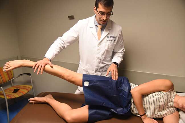 Dr. Jorge Chahla conducting a hip assessment